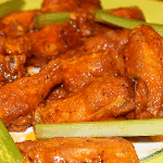 Crispy deep fried chicken wings coated in Buffalo wing sauce