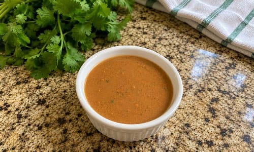 Close-up of Cheesecake Factory Tamarind Cashew Dipping Sauce in a white ramekin